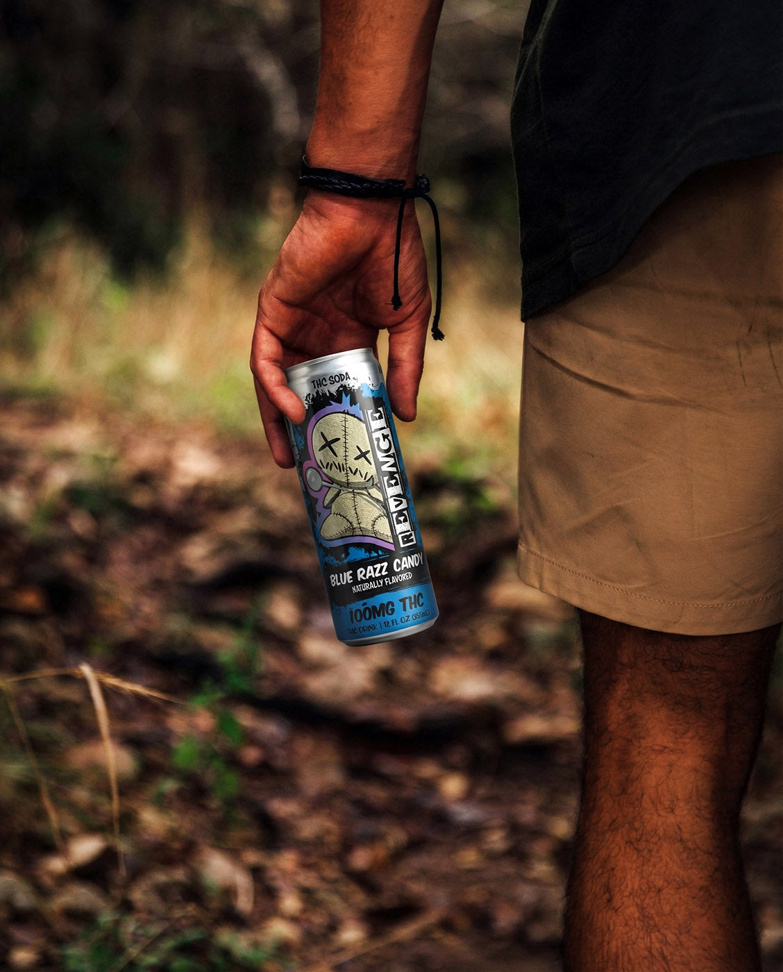 revenge blue razz candy delta 9 thc soda man holding can on a walk